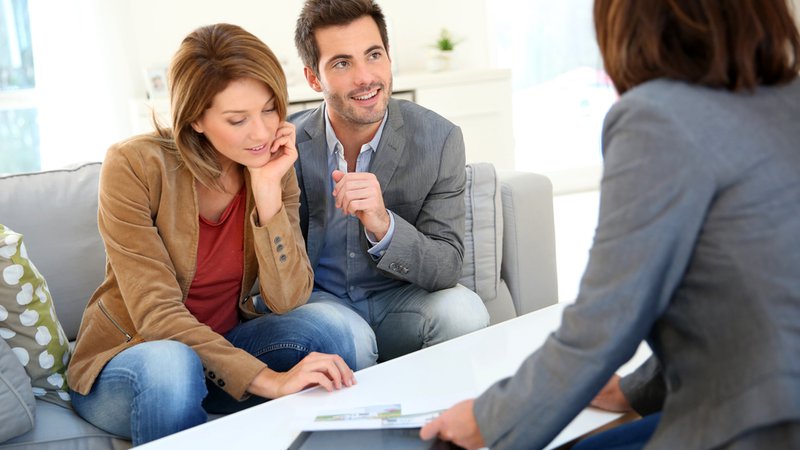 Couple meeting financial adviser for real estate project
