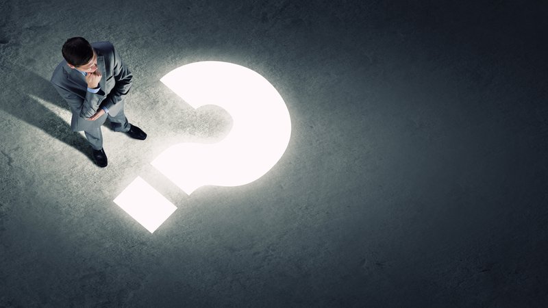 Top view of businessman looking at question mark on floor